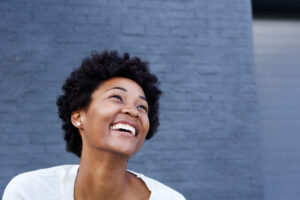 A happy woman experiences the pink cloud in recovery.