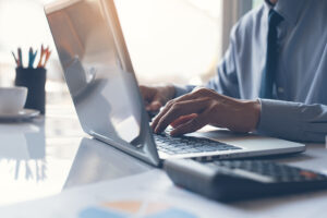 A professional works on a computer.