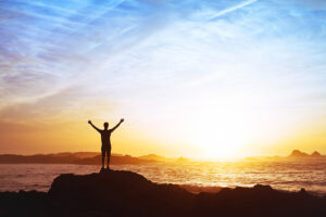 A man celebrates his sobriety with a walk on the beach.